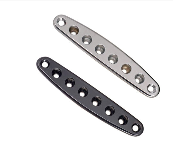 Two metal brackets, one silver and one black, on a white background