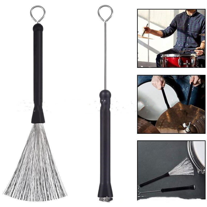 A pair of black wire drum brushes with metal handles and plastic bristles, displayed alongside images showing their use on a drum set.