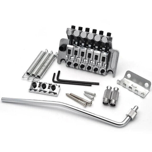 A set of guitar bridge parts including a double shake tremolo system, springs, screws, and tools, all laid out on a white background.