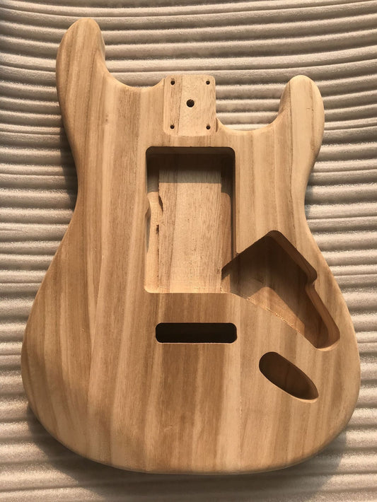 Natural maple wood guitar body for a Stratocaster style electric guitar, showing the raw wood finish without any paint.