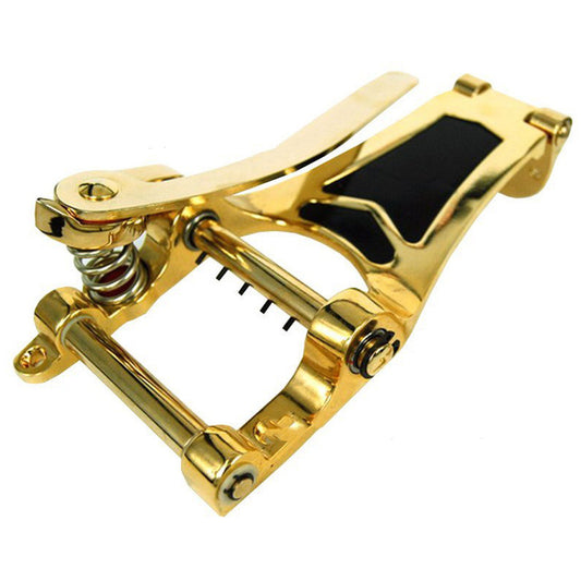 A gold-colored alloy guitar bridge with a drawstring tremolo system.