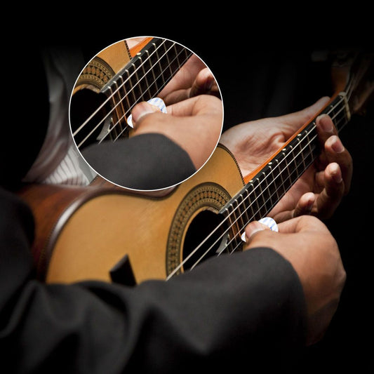 A person holding a guitar with a close-up of a white guitar pick placed between the strings.