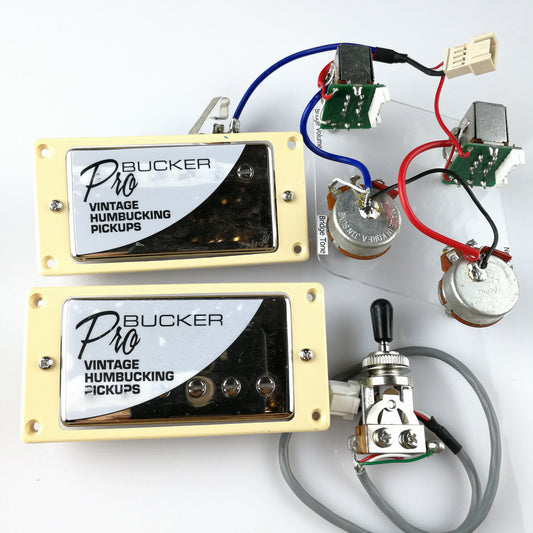 Electric guitar pickup set with wiring and knobs, displayed on a white surface.