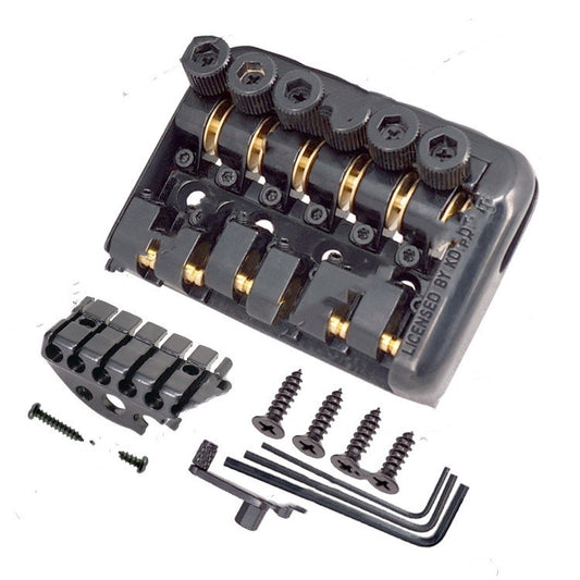 Fixed headless electric guitar bridge tailpiece with various tools for installation.
