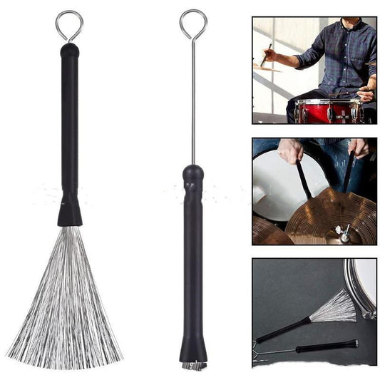 A pair of black wire drum brushes with metal handles and plastic bristles, displayed alongside images showing their use on a drum set.
