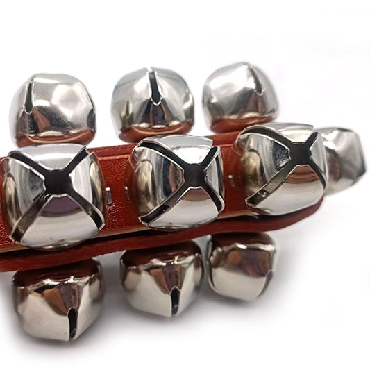 A set of silver-colored handbells with wooden handles, arranged in a line.