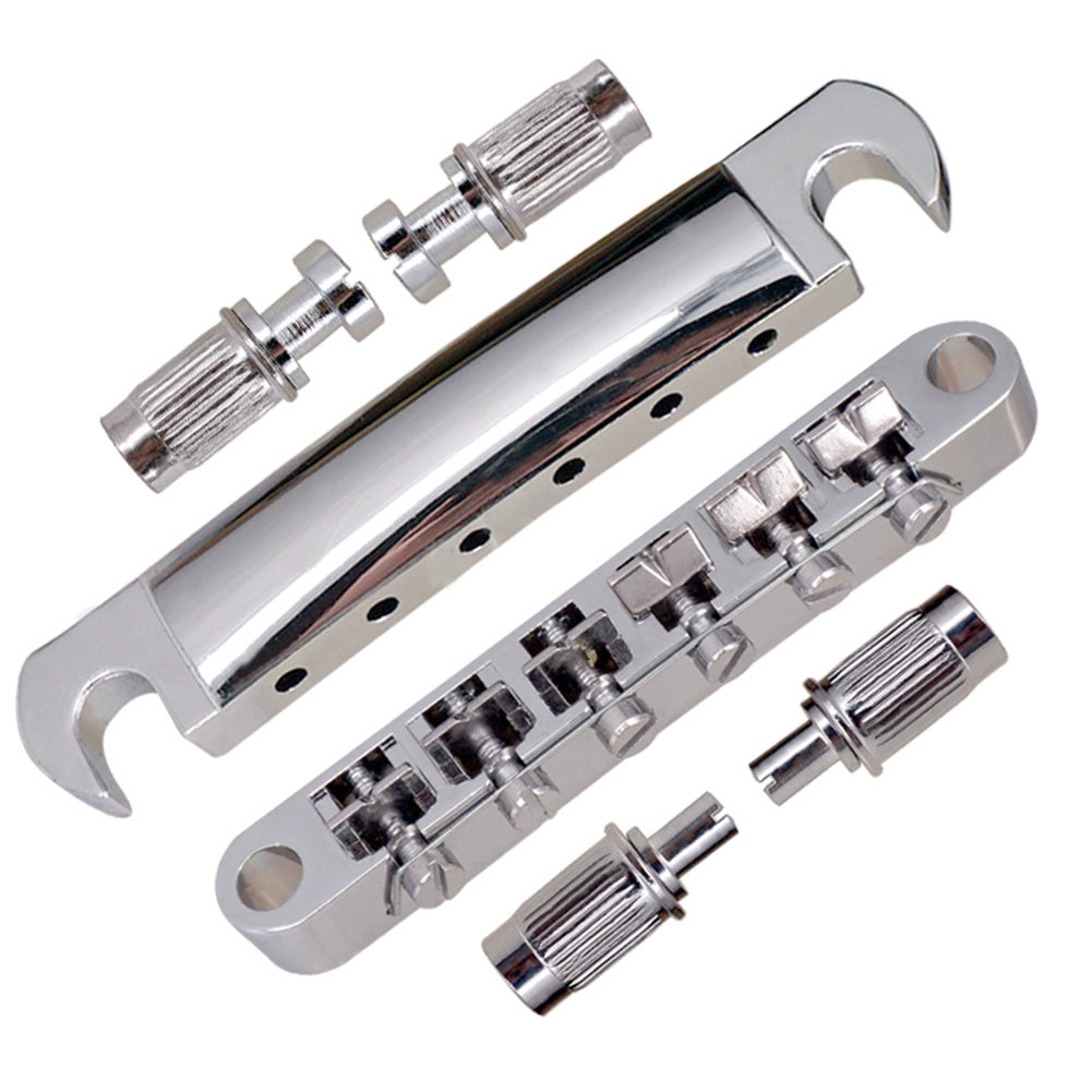Chrome guitar bridge assembly with screws on a white background
