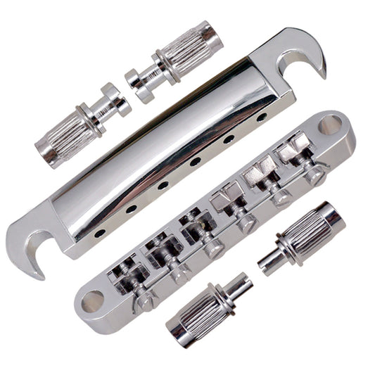 Chrome guitar bridge assembly with screws on a white background