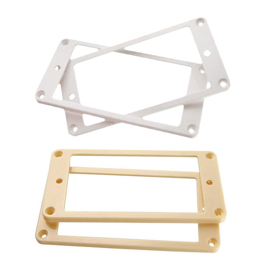 Two flat bottom electric guitar pickup frames, one cream yellow and one white, displayed on a neutral background.