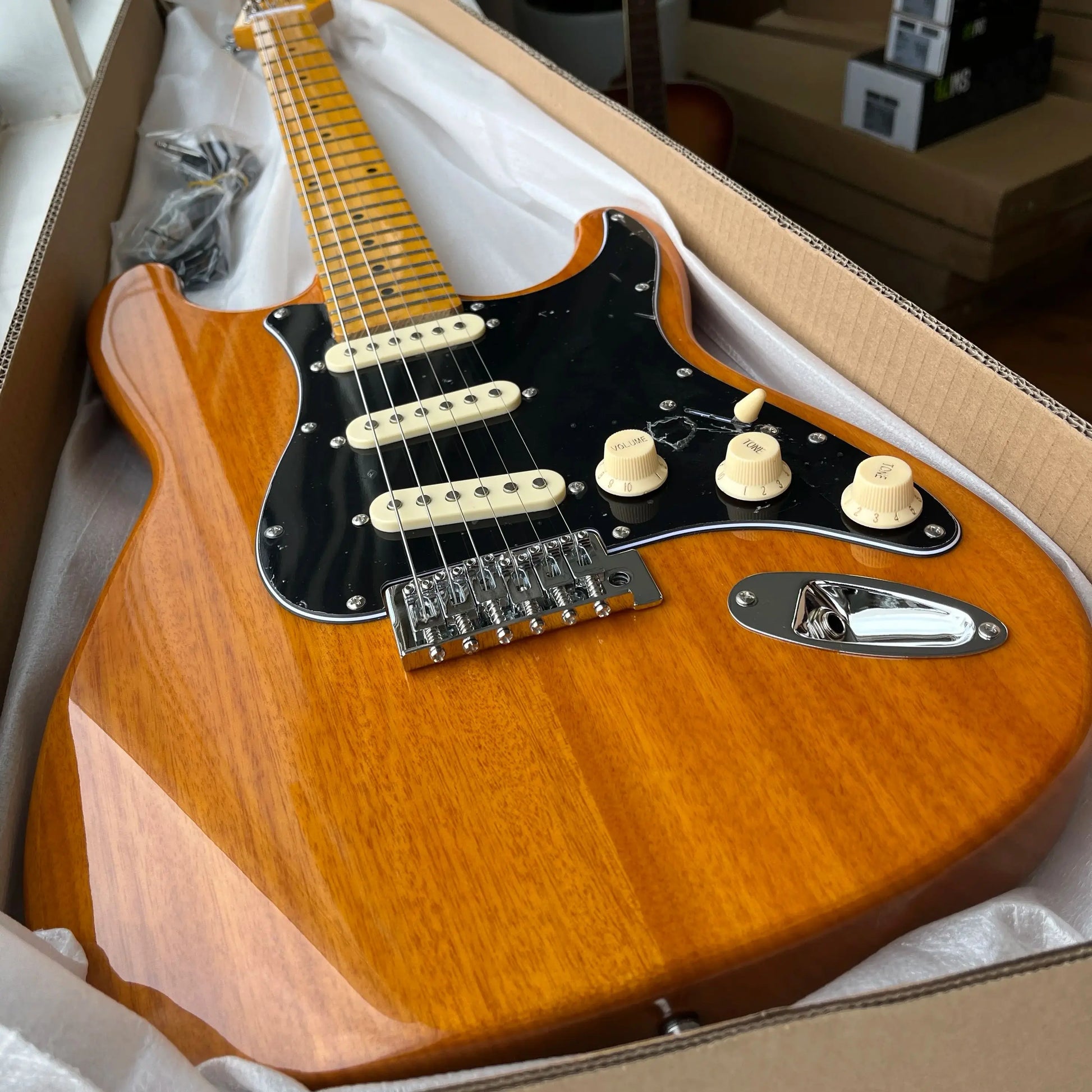 Customized wooden-colored electric guitar with maple fretboard. Durable material, beautiful sound. Free shipping.