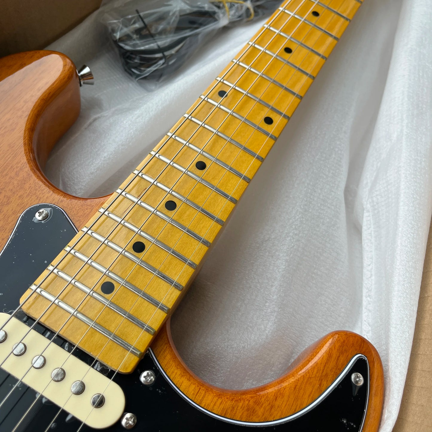 Customized wooden-colored electric guitar with maple fretboard. Durable material, beautiful sound. Free shipping.