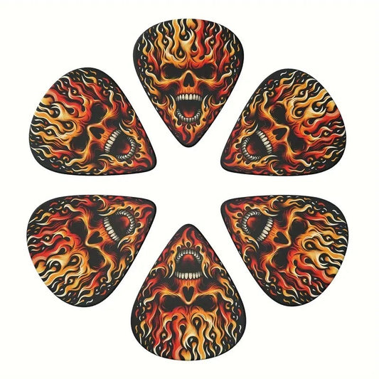 A set of six guitar picks with a painted shrapnel design featuring flames and skulls.