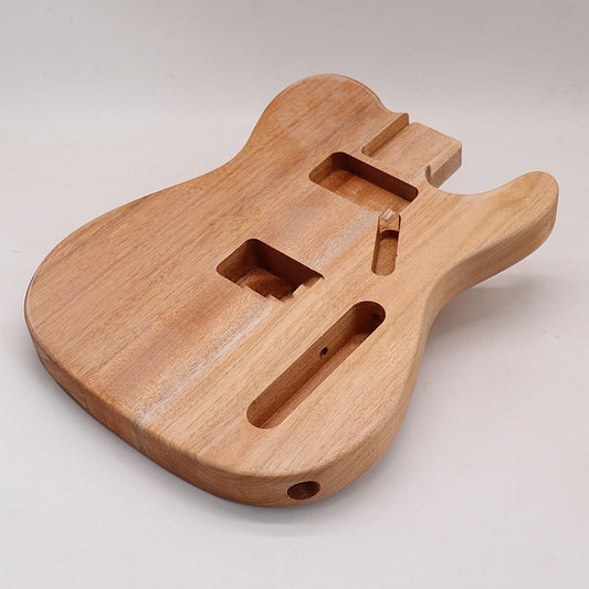 A T-shaped guitar body made of light-colored wood, likely spruce or pine, with a visible grain pattern.